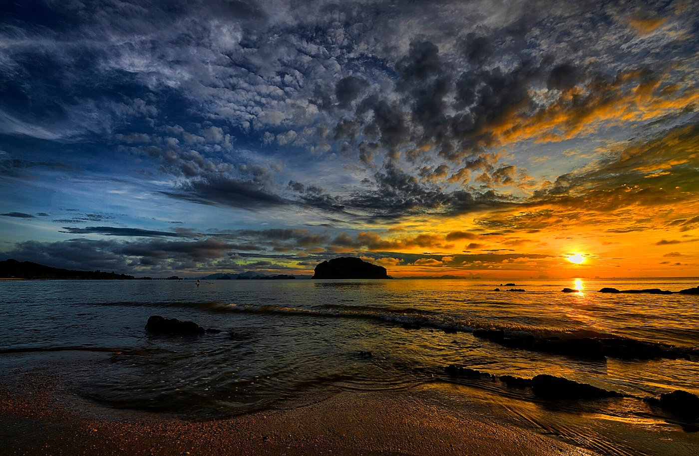 The sun rising over a calm sea