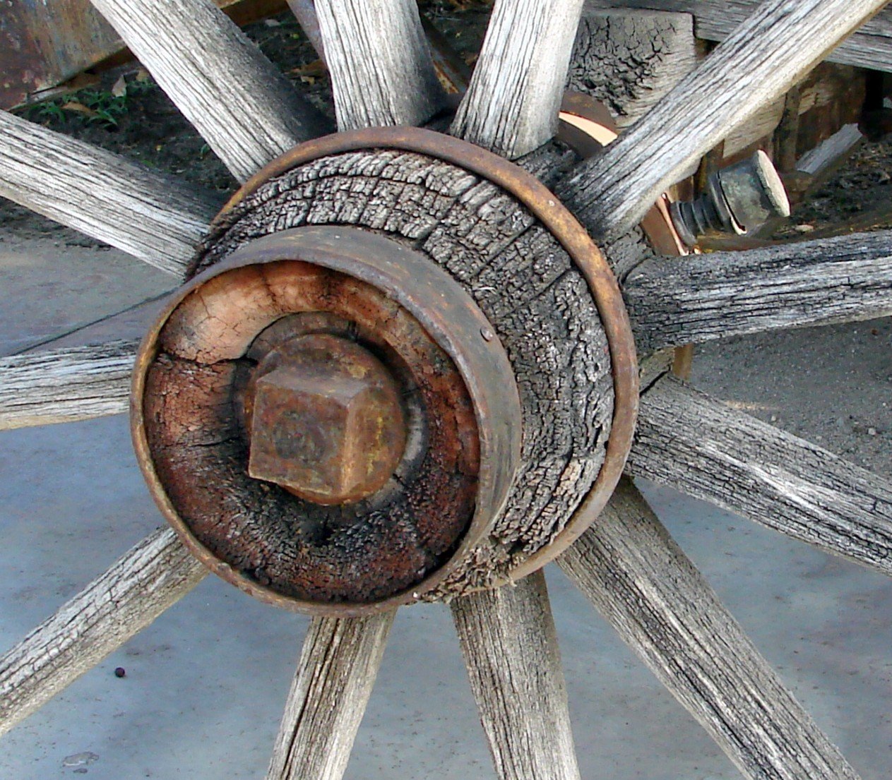 The hub of a wooden wheel with every spoke running to it