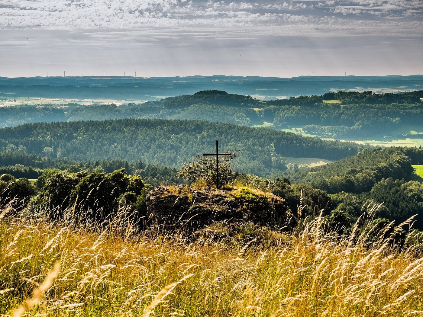 A summit cross overlooking the valley below