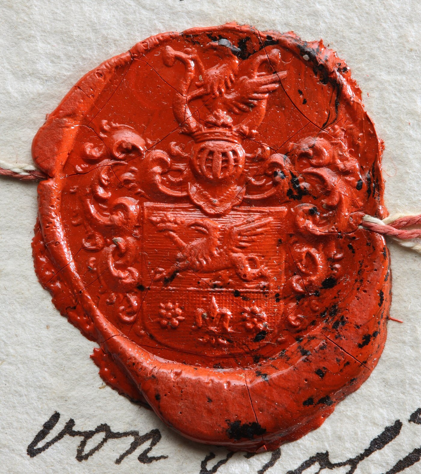 A red wax seal on a document