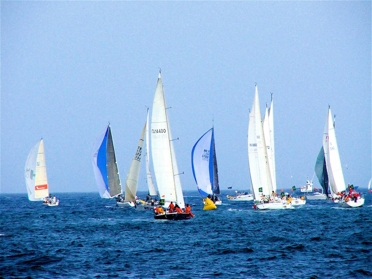 Sailing boats with their sails full of wind