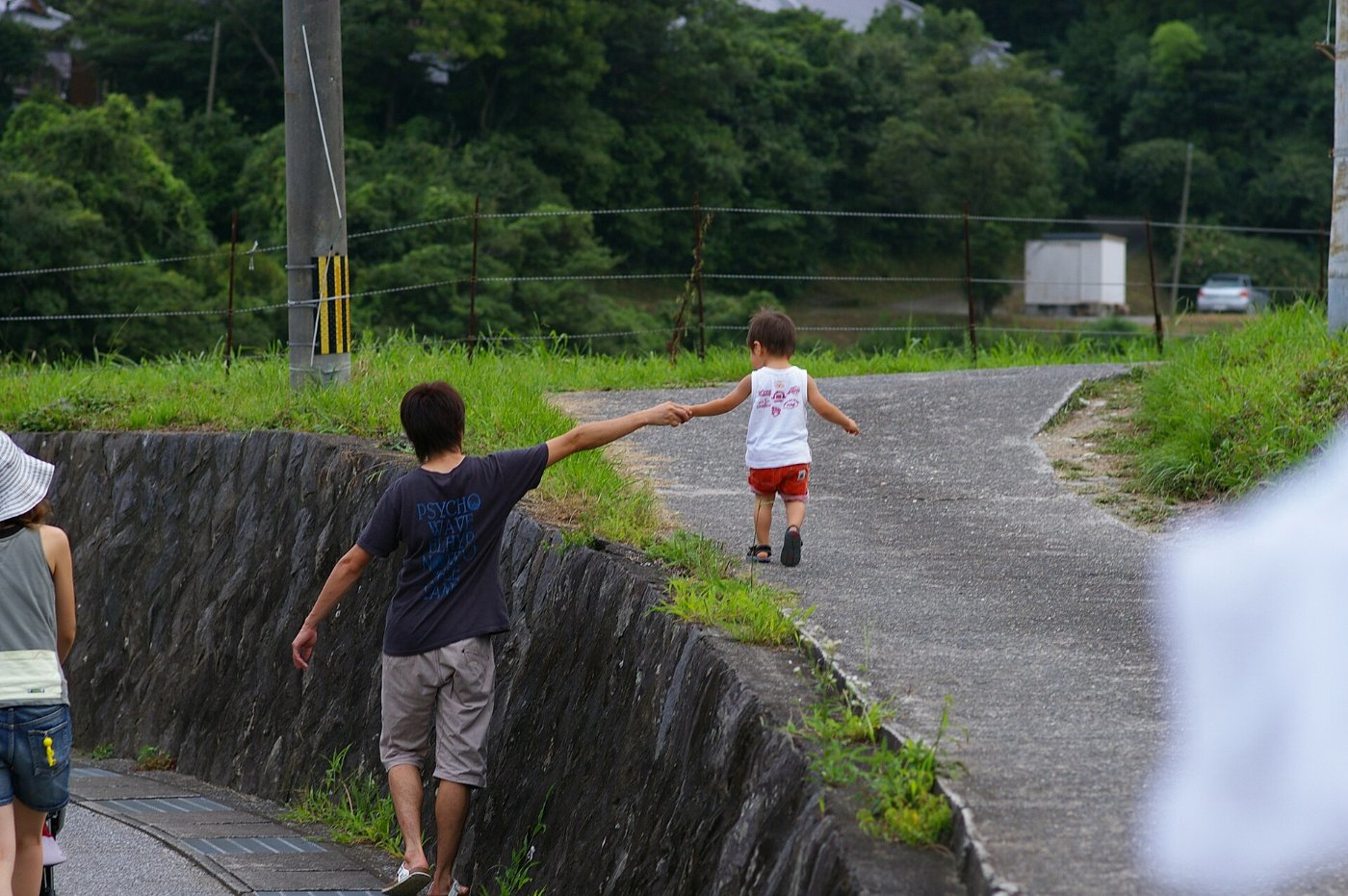 A father and his small child walking hand in hand